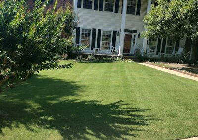 Two-story suburban office with a well-manicured lawn and white columns. - Little Rock Lawn Care and Mowing Services by Apex Lawn Care